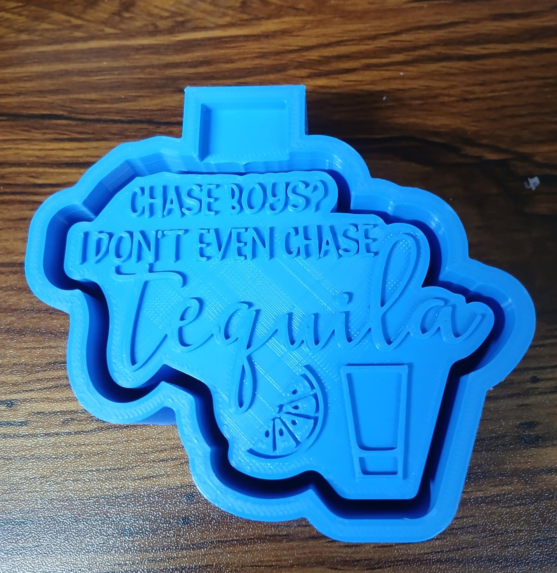 Blue tequila-themed 3d housing on a wooden counter surface for purchase of silicone mold