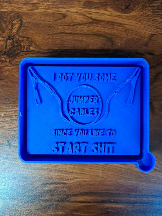 Blue 3d mold housing with text about jumper cables on a wooden surface used to sell silicone molds
