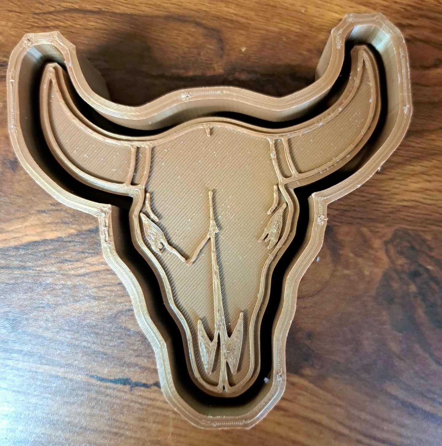 3D-printed bull skull design on a wooden surface used to make silicone molds