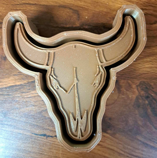 3D-printed bull skull design on a wooden surface used to make silicone molds