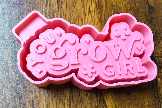 Pink 3d housing with 'You Grow Girl' text on a wooden surface to be purchased as a silicone mold