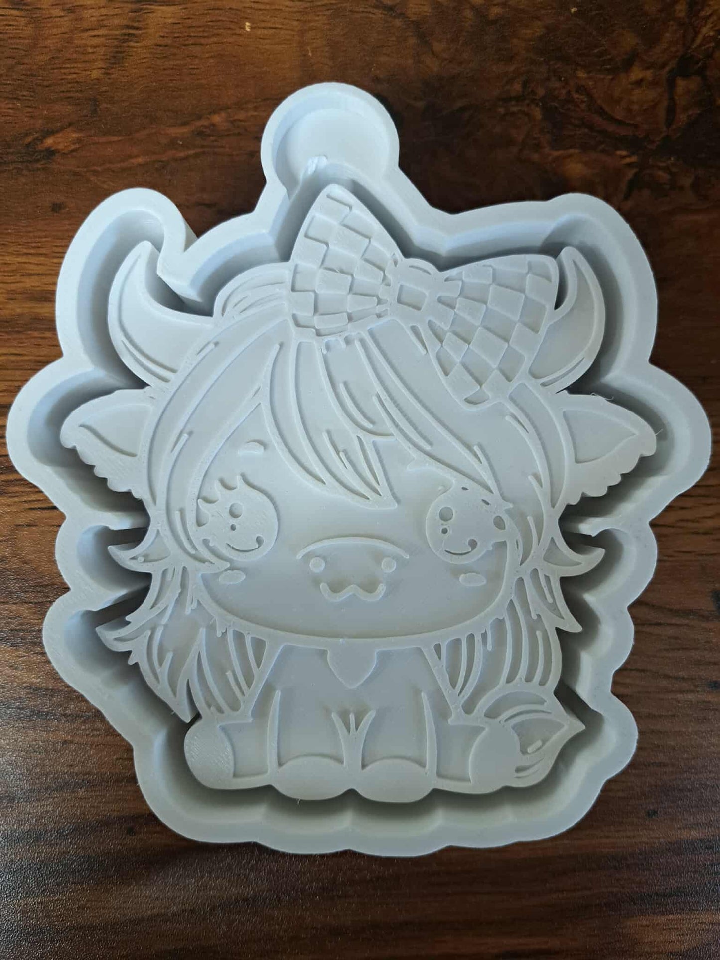 Cow Sitting With Checkered Bow Mold